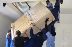 Movers moving heavy furniture